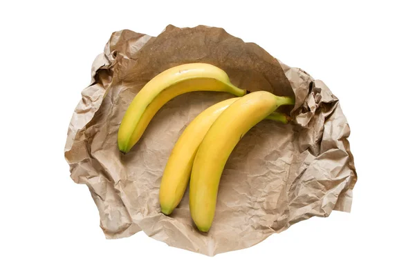 Três Bananans Amarelos Embrulhados Papel Artesanal Sobre Fundo Branco — Fotografia de Stock