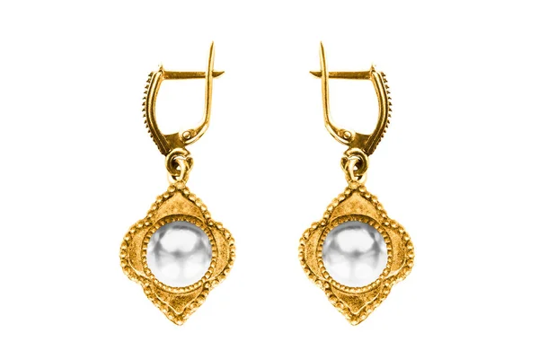 Vintage old gold pearl earrings isolated over white