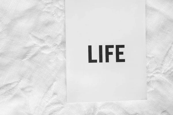 Clothing Label Says Life White Textile Background Closeup — Stock Photo, Image