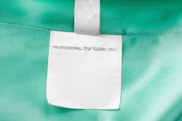 Clothing Label Says Professional Dry Clean Only Green Textile Background — Stock Photo, Image