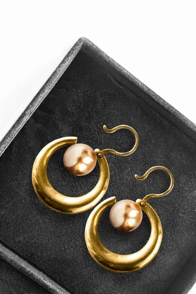 Vintage gold earrings with golden pearls in black jewel box
