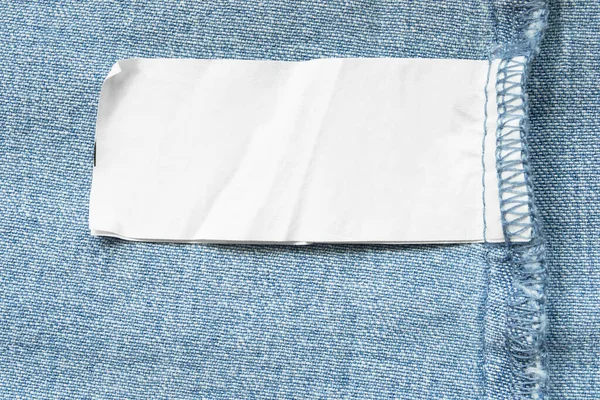 Étiquette Vêtement Vierge Sur Fond Denim Bleu Gros Plan — Photo