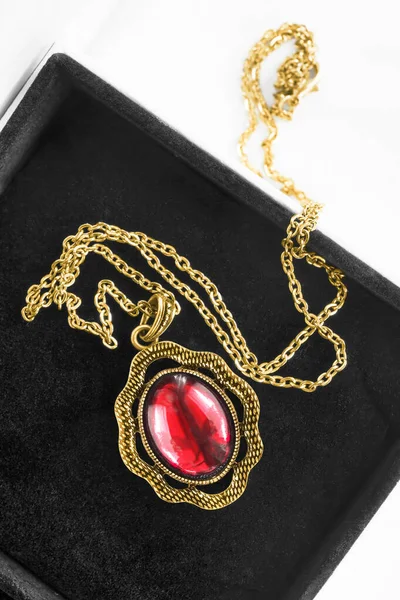 黑色珠宝盒内嵌有红宝石大吊坠的老式金项链 — 图库照片