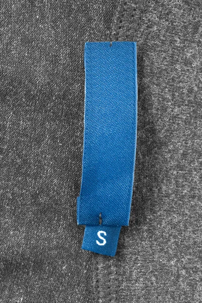 Taille Étiquette Bleue Sur Fond Gris Tricoté — Photo