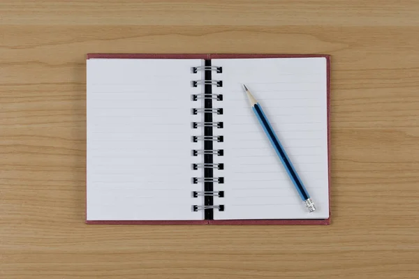 Blank notebook and pencil on wood table. — Stock Photo, Image