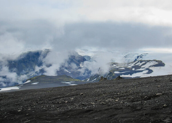 Epic landscape around plateau of Morinsheidi with mountains and glaciers in the clouds, between the Eyjafjallajokull and Myrdalsjokull in southern Iceland