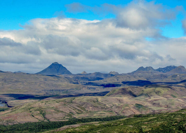 Breathtaking landscape of green valley of Thorsmork, with volcanoes, glaciers, green forest and blue sunny sky in summer day on Laugavegur and Fimmvorduhals trails cross point, Highlands of Iceland