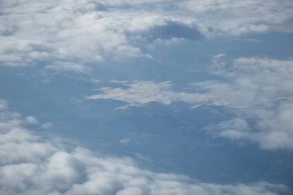 青空と白い雲を持つ平面窓からの航空写真 — ストック写真