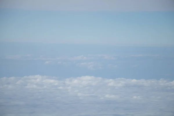 青空と白い雲を持つ平面窓からの航空写真 — ストック写真