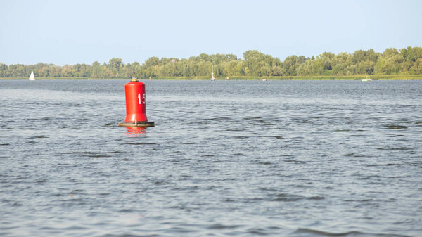 A red buoy on the Dnieper river in Kiev, Ukraine, for the safety and security of the boats travelling on the water.