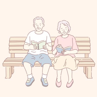 Orta yaşlı çift kitap okuma ve bankta oturmak