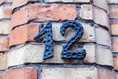 House number twelve 12 in cut out metal, textured, polished, weathered  in designer font from Sweden clipart