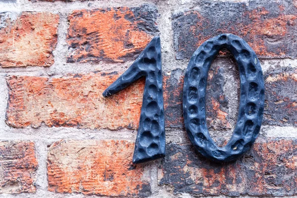 House number ten 10 in cut out metal, textured, polished, weathered  in designer font from Sweden