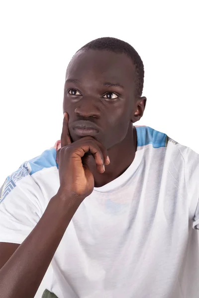 Genç yakışıklı sudan adam dalmış duygusal arıyorsunuz off yüz şu beyaz tshirt, beyaz arka plan üzerinde izole kopya alanı ile portre biçiminde giyen düşünce yanağına el ile