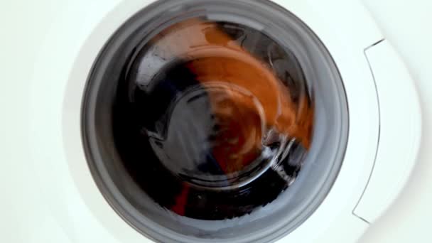 No sound, slow motion. Twenty 20 seconds of washing tumbling in front load washing machine. — Stock Video