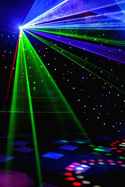 Helle Nachtclub-Laserlichter, die sich durch den Rauch der Rauchmaschine schneiden und Licht und Regenbogenmuster auf der Tanzfläche erzeugen. Laserlichter mit Bokeh im Hintergrund. Inspiration für Mardi Gras oder Nightlcub Promotions. — Stockfoto