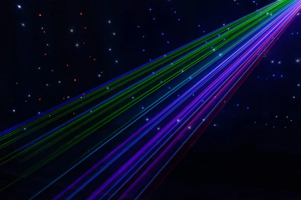 Bright nightclub laser lights cutting through smoke machine smoke making light and rainbow patterns on the dance floor. Laser lights with bokeh in the background. Inspiration for Mardi Gras or nightlcub promotions. — Stock Photo, Image