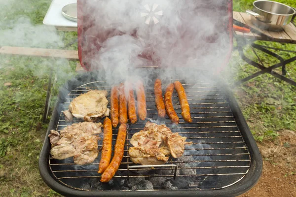 Smoking meat on barbecue grill