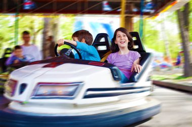 İki çocuk, gülüyor, eğleniyor bir çarpışan araba hareket bulanıklığı