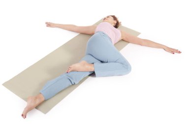 Beautiful Yoga: Reclined Spinal Twist - Real senior woman doing Supta Matsyendrasana exercises clipart
