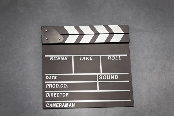 Movie clapper board on gray background - film, cinema and video photography concept