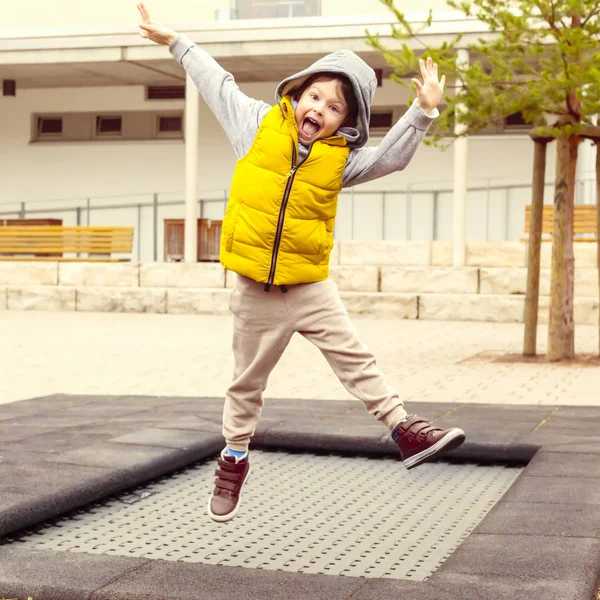 Ευτυχισμένο αγόρι υψηλά άλματα σε τραμπολίνο στο πάρκο — Φωτογραφία Αρχείου