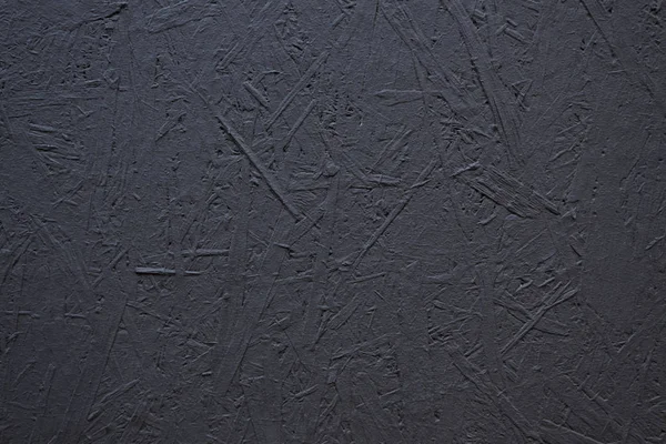 Texture of a wood splinter pressed wall, painted black