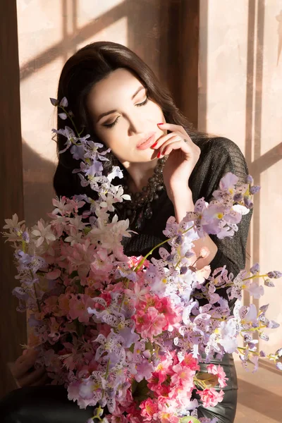 優しいピンクの花と若いブルネットの女性 — ストック写真
