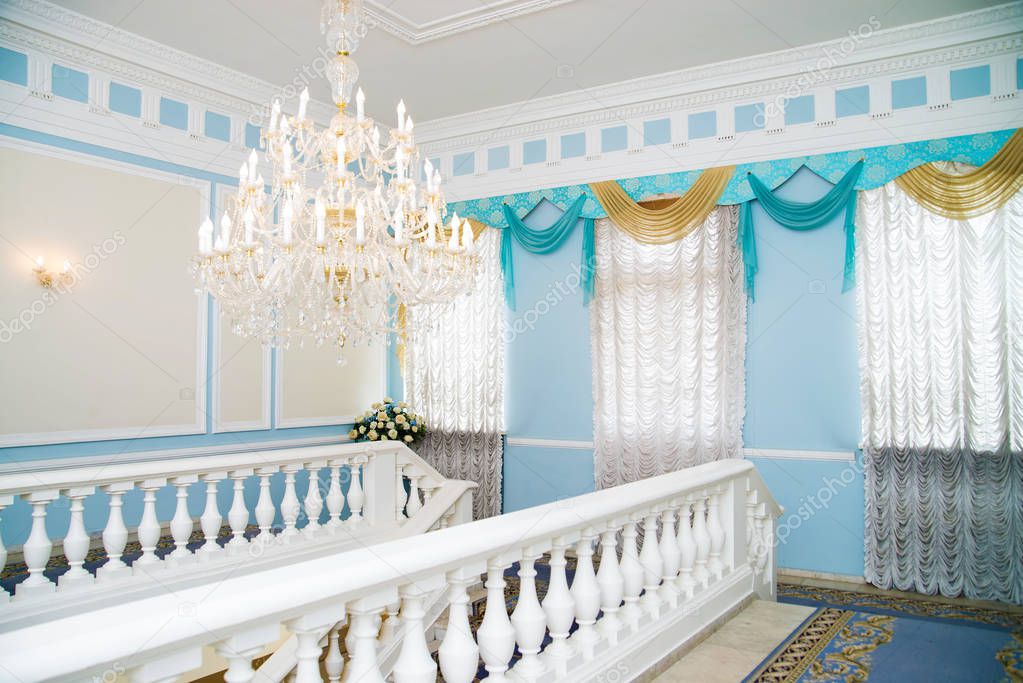 vintage crystal chandelier in blue interior 