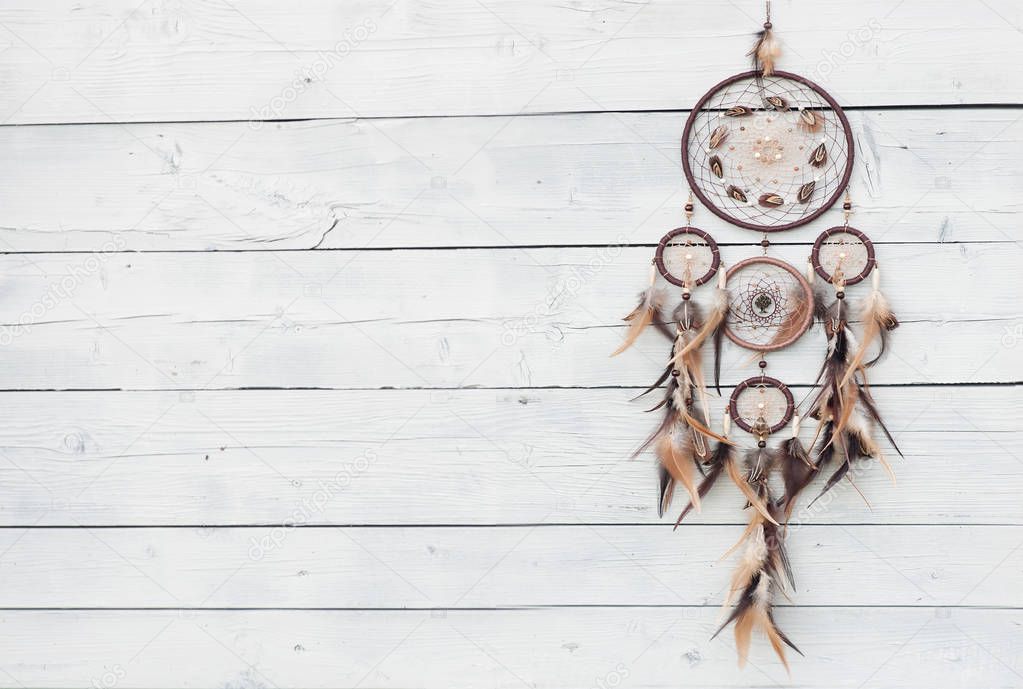 Traditional indian talisman dreamcatcher on wooden background 