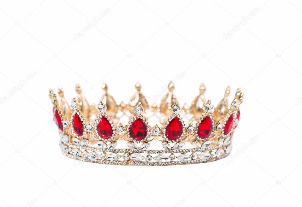 Crown with red gemstones isolated on white background