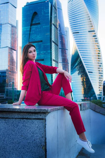 Street fashion business style, attractive model on skyscrapers background. Success concept