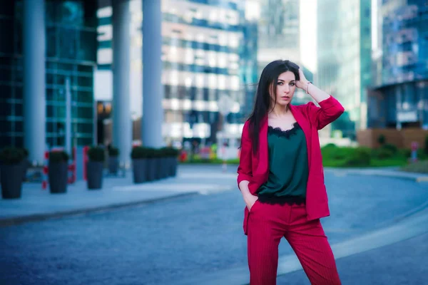 Street fashion business style, attractive model on skyscrapers background. Success concept
