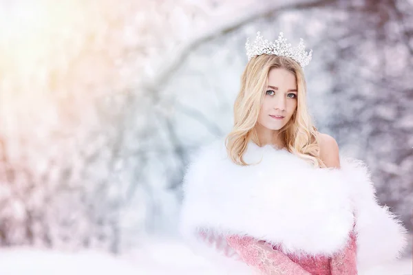 Snow queen, princess with crown and fur coat. Winter fairy tale