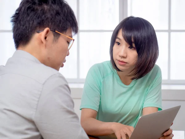 Two Young People Discussing in front of laptop