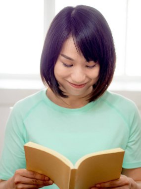 Genç güzel kız kitap okuyor.