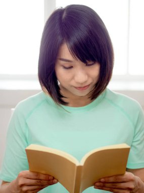 Genç güzel kız kitap okuyor.