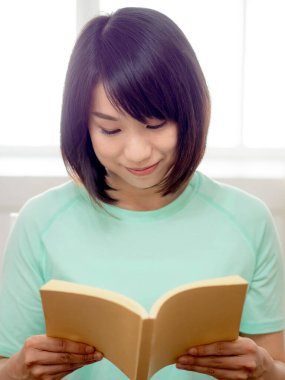 Genç güzel kız kitap okuyor.