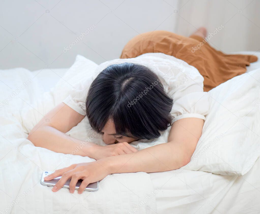 young woman tired and sleeping with cellphone