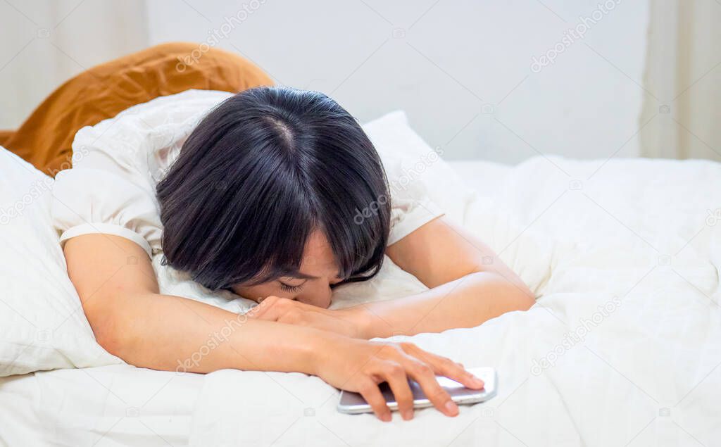 young woman tired and sleeping with cellphone