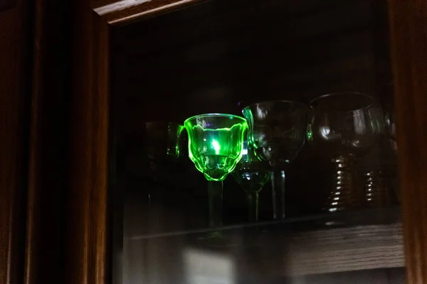 Strong blue laser pointer hits a crystal glass