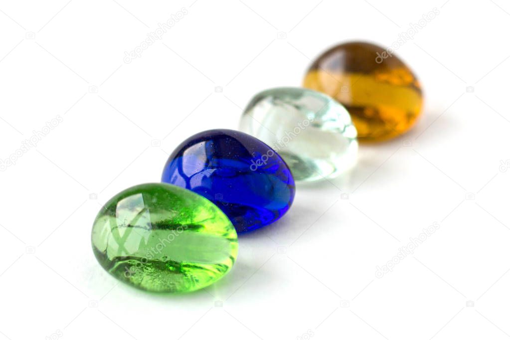 Color glass balls , green, blue, white, orange. White background.