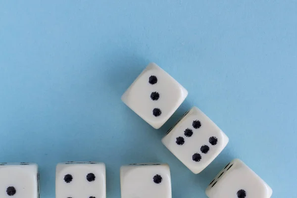 Arrow up. White gaming dices on light blue background. victory chance and lucky. Flat lay style, place for text. Top view and Close-up cube. Concept business and game. Spectacular background pastel.