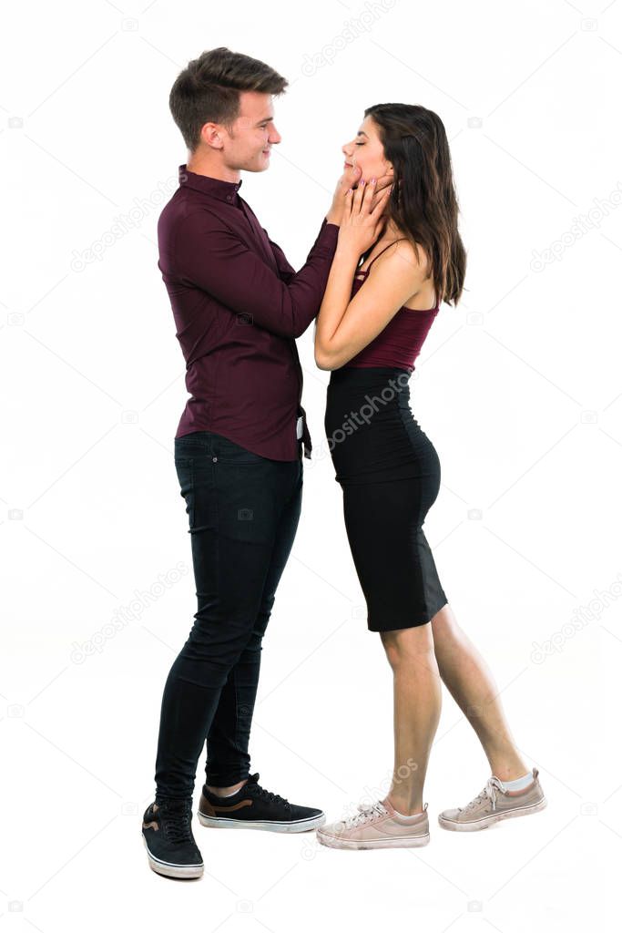 Young teenager couple hugging on isolated white background