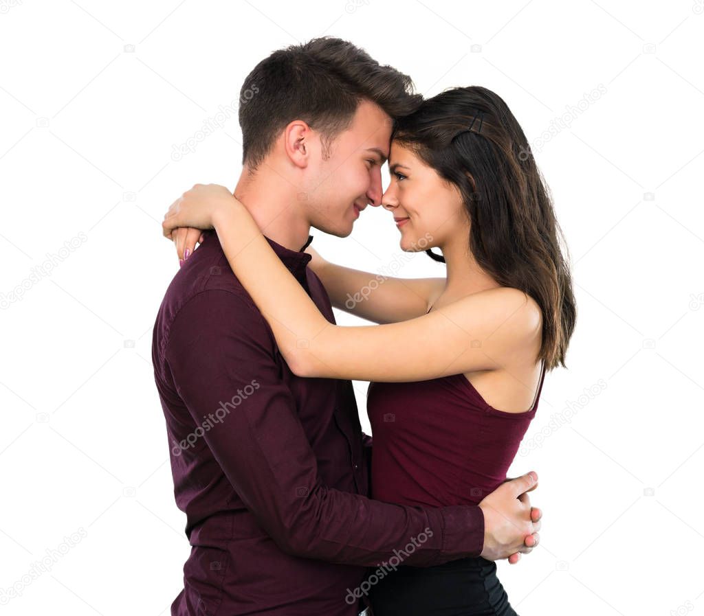 Young teenager couple hugging on isolated white background