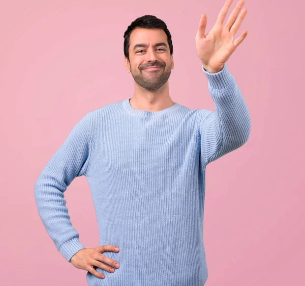 Man Blue Sweater Saluting Hand Pink Background — Stock Photo, Image