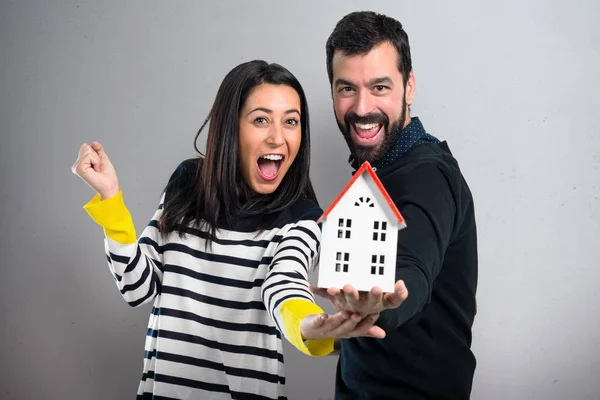 Couple Holding Little House Grey Background — Stock Photo, Image