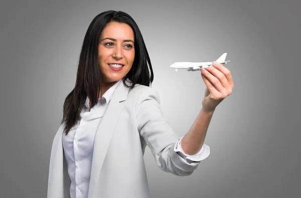 Pretty Woman Holding Toy Airplane Grey Background — Stock Photo, Image