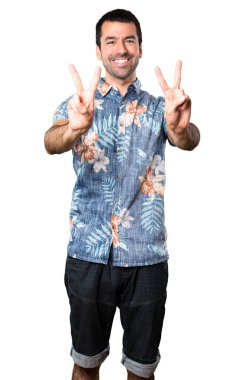 Beyaz arka plan üzerinde zafer jest yapma çiçek forması ile yakışıklı adam izole