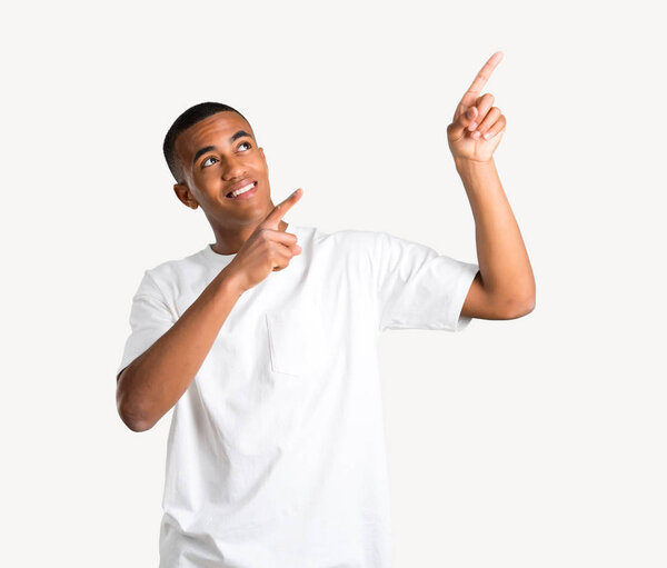 Young african american man pointing with the index finger a great idea and looking up on isolated background